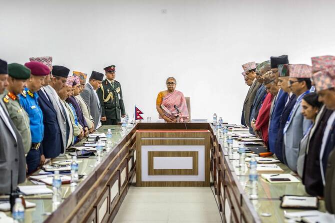 Newly-elected Prime Minister of Nepal’s interim government Sushila Karki, center, along with officials, observes a moment of silence to pay tribute to those who lost their lives in recent protests in Katmandu on Sept. 14, 2025. (AFP)