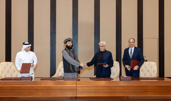 Afghan Defence Minister, Mullah Mohammad Yaqoob Mujahid (second-left) and Pakistan's Defence Minister, Khawaja Muhammad Asif (second-right) shake hands, following the signing of a ceasefire agreement, during a negotations meeting mediated by Qatar and Turkey, in Doha, Qatar, October 19, 2025. (Reuters/File)