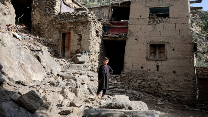A boy stands in front of houses damaged by a deadly earthquake that struck Afghanistan's Kunar and Nangarhar provinces, at Masud village in Nurgal district, Kunar province, Afghanistan, September 4, 2025. Photo: REUTERS/Sayed Hassib/File Photo