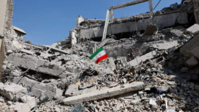 An Iranian flag stands in the rubble following a strike on a police station in Tehran, Iran, March 4. Photo: Reuters