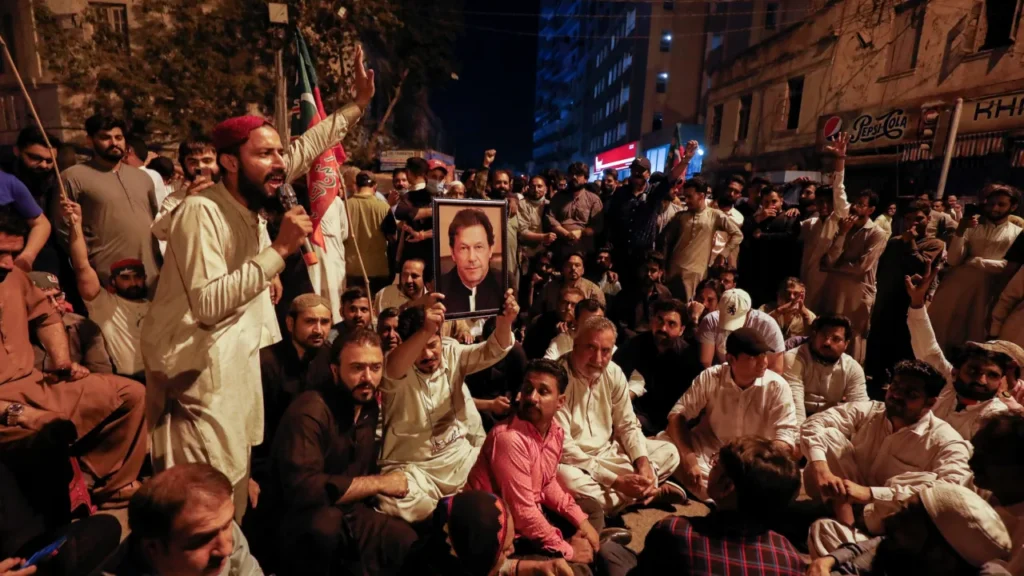 Supporters of Imran Khan chant slogans as they protest in Lahore, Pakistan