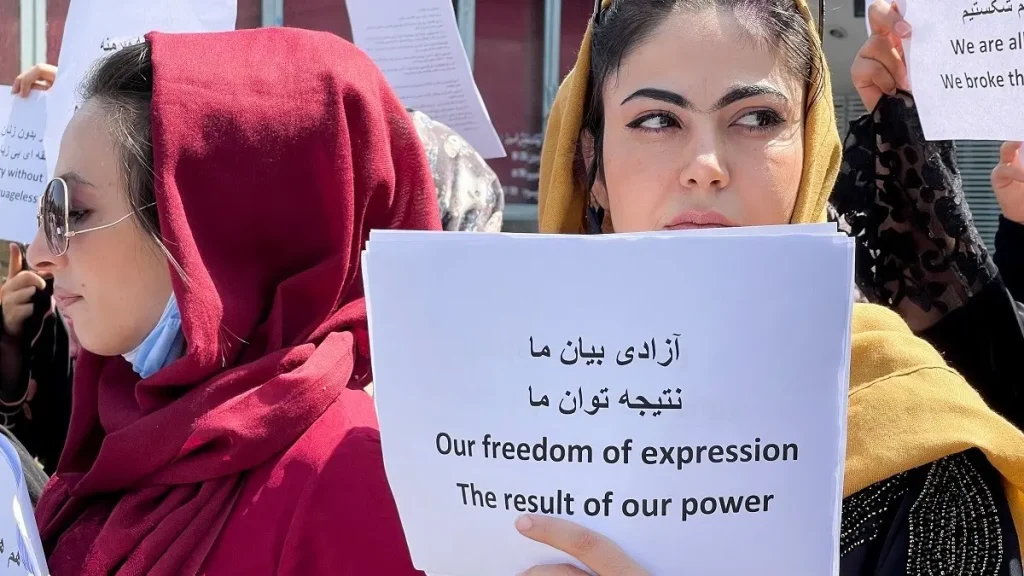 Afghan women's rights defenders and civil activists protest to call on the Taliban for the preservation of their achievements and education, in front of the presidential palace in Kabul