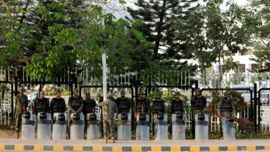 Paramilitary soldiers, with shields and helmets stand outside parliament building in Islamabad, Pakistan