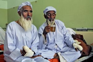 Afghan men, who their fingers have been cut off by Taliban fighters as a punishment for voting, rest in a hospital in Herat, west of Kabul, Afghanistan, Sunday, June 15, 2014. (AP Photo)