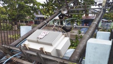 In this photo provided by Myanmar Military True News Information Team on Sunday, 14 May, 2023, a lamppost attached with electrical transformer damaged by Cyclone Mocha lines on a street in Gwa township, Rakhine State. (Military True News Information Team via AP)