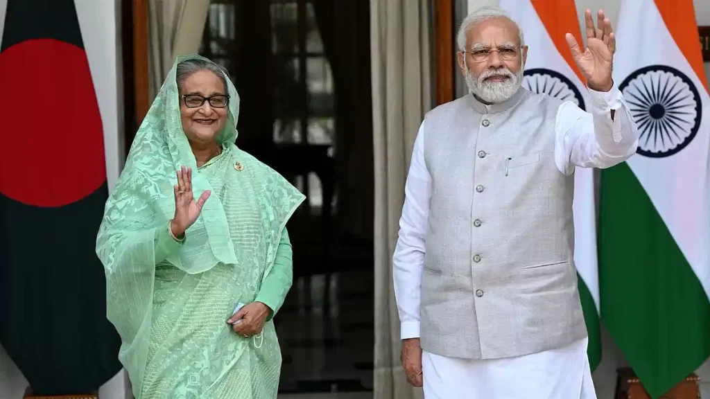 India's Prime Minister Narendra Modi (R) and his Bangladesh counterpart Sheikh Hasina wave as they pose for pictures before their meeting at the Hyderabad House in New Delhi on 6 September, 2022AFP