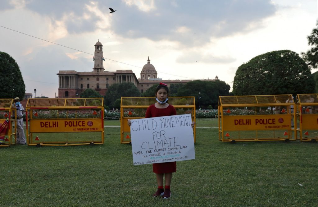 Licypriya Kangujam, 8, India's young climate activist, holds a poster during a protest demanding to pass a climate change law outside the parliament in New Delhi, India, on September 23, 2020. (REUTERS/Anushree Fadnavis)