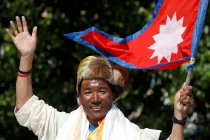 Nepalese mountaineer Kami Rita Sherpa waves upon his arrival after climbing Mount Everest for the 24th time in 2019 [File: Navesh Chitrakar/Reuters]