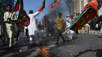 Supporters of Pakistan's former Prime Minister Imran Khan throw stones towards police during a protest against Khan's arrest, in Peshawar, Pakistan.