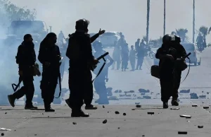 Supporters of Pakistan's former Prime Minister Imran Khan throw stones towards police during a protest against Khan's arrest, in Peshawar, Pakistan.