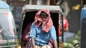 A rickshaw puller wraps his face with a gamcha to protect from the scorching heat. Day labourers are suffering the most. 