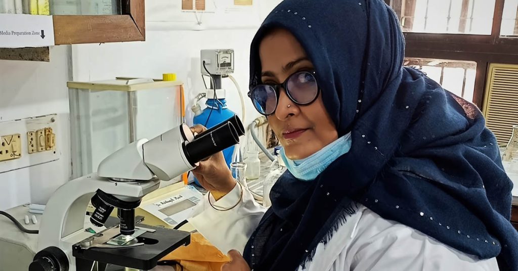 Prof Gawsia Wahidunessa Chowdhury, PhD, identifies microplastics from sediment samples using a phase-contrast microscope.