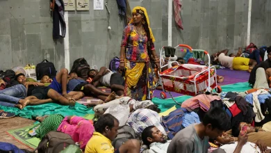 Laxmi Kumar pushes a cradle carrying her three-year-old son at a temporary shelter for people evacuated from Kandla port in Gandhidham, in the western state of Gujarat, India. [Francis Mascarenhas/Reuters]