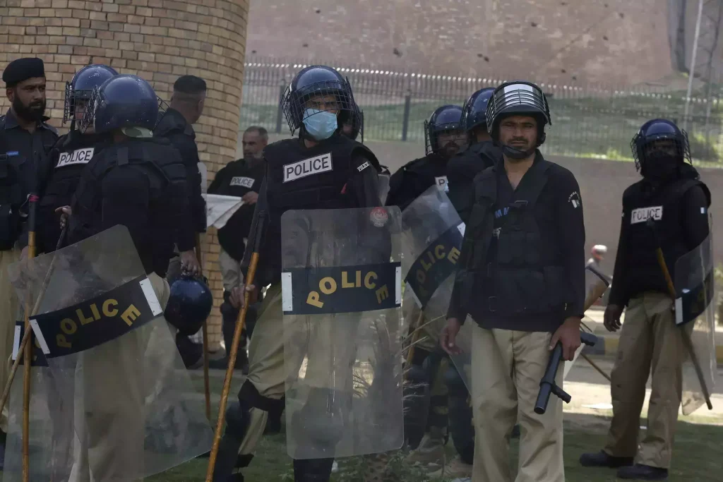Police officers with riot gears stand alert to ensure security, in Peshawar, Pakistan, Thursday, May 11, 2023. Pakistani police arrested nearly 1,600 supporters of the country's former Prime Minister Khan on charges of damaging public property, attacking military installations and burning down a sprawling residence of a top army commander in the eastern city of Lahore, officials said.