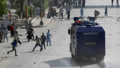 Supporters of Pakistan’s former Prime Minister Imran Khan throw stones at police during a protest against Khan’s arrest, in Peshawar, Pakistan, May 10, 2023. REUTERS/Fayaz Aziz