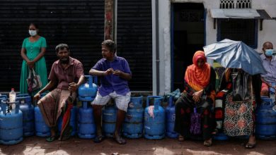 People wait in a line to buy domestic gas tanks near a distributor, amid the country's economic crisis, in Colombo, Sri Lanka, May 23, 2022. REUTERS/Dinuka Liyanawatte