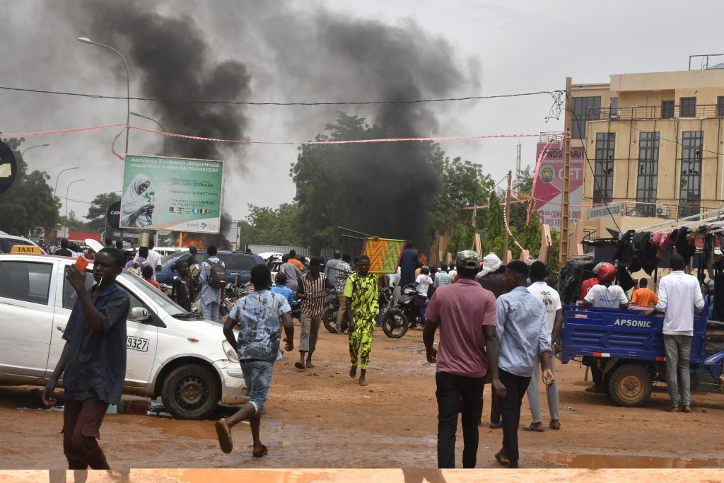 A general view of billowing smoke as supporters of the Nigerien defence and security forces attack the headquarters of the Nigerien Party for Democracy and Socialism, in Niamey on July 27, 2023 AFP