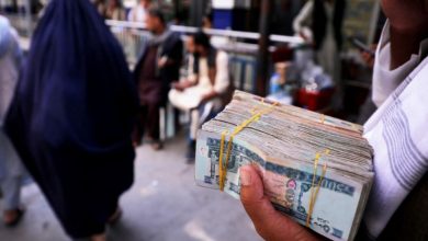 A person holds a bundle of Afghan afghani banknotes at a money exchange market, following banks and markets reopening after the Taliban took over in Kabul, Afghanistan, September 4, 2021. REUTERS/Stringer/File Photo