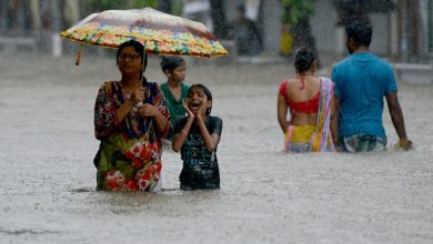 People wade through a flooded street in Mumbai, India, on August 29th, 2017.