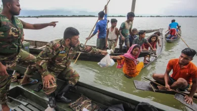 Soldiers provide food to residents following heavy monsoon rain in Goyainghat, Bangladesh [File: Mamun Hossain/AFP]