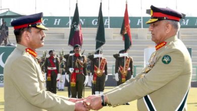 Outgoing Chief of Army Staff General Qamar Javed Bajwa hands over the baton of command over to the newly appointed Army Chief General Asim Munir (L), during a ceremony at the army headquarters in Rawalpindi, Pakistan November 29, 2022. Inter Services Public Relations (ISPR)/Handout via REUTERS