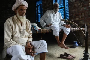 Safahat, right, with his uncle at their house in Mewli village, Nuh [Md Meharban/Al Jazeera]