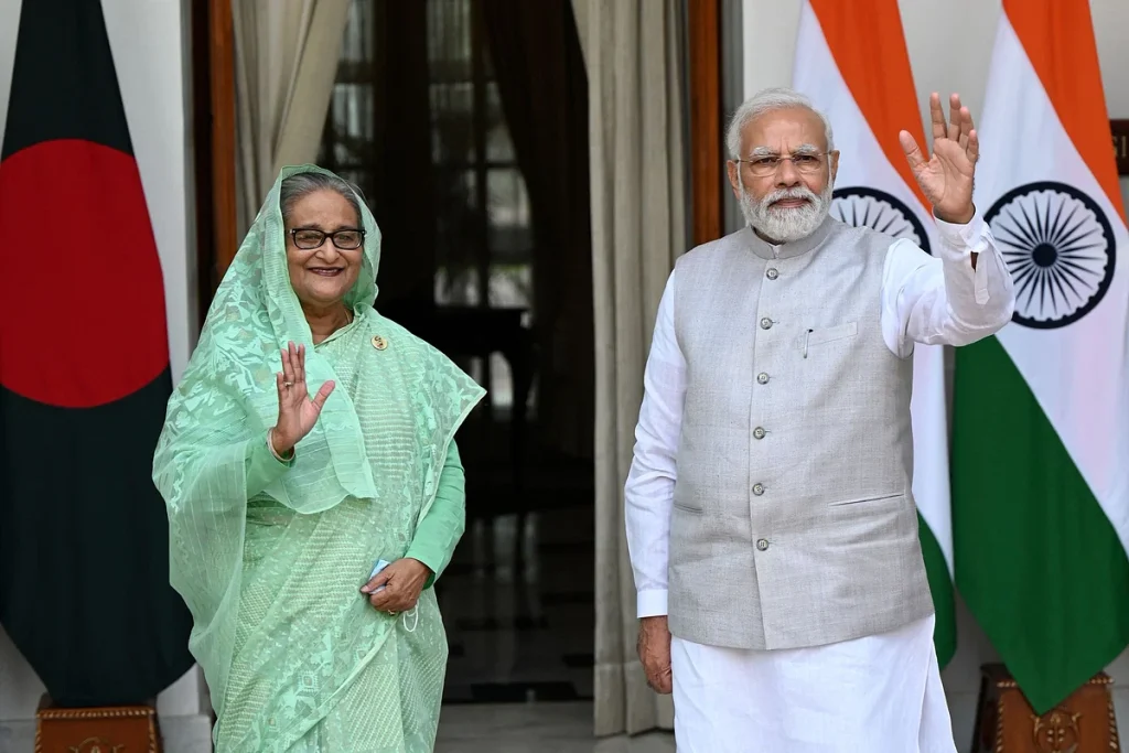 India's Prime Minister Narendra Modi (R) and his Bangladesh’s counterpart Sheikh Hasina wave as they pose for pictures before their meeting at the Hyderabad House in New Delhi on 6 September, 2022 AFP