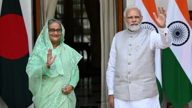 India's Prime Minister Narendra Modi (R) and his Bangladesh’s counterpart Sheikh Hasina wave as they pose for pictures before their meeting at the Hyderabad House in New Delhi on 6 September, 2022 AFP