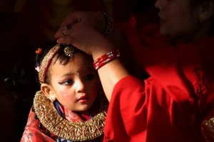 A Nepalese girl is prepared by her mother for a child marriage ceremony in Kathmandu on November 21, 2009 [Shruti Shrestha/Reuters]