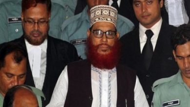 FILE - In this, Nov. 21, 2011, file photo, Bangladeshi police officers escort Delwar Hossain Sayeedi, a leader of Bangladesh's largest Islamic party Jamaat-e-Islami, as he leaves after an appearance before a special tribunal in Dhaka, Bangladesh.