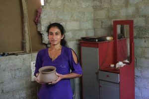 Duleeka Madhunamali repairs clay pots which she sells to feed her three children. One pot earns her less than half a penny