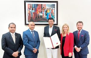 Mano Sekeran (center) with letter of accreditation.