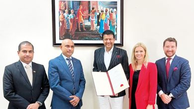 Mano Sekeran (center) with letter of accreditation.
