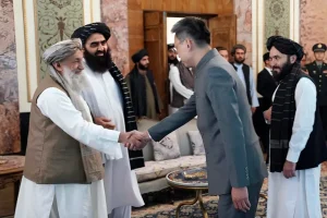 China's new ambassador to Afghanistan Zhao Sheng shakes hand with Taliban Prime Minister Mohammad Hasan Akhund [Handout/Taliban Prime Minister Media Office via AP Photo]