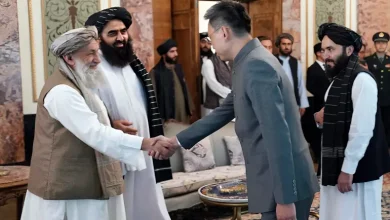 China's new ambassador to Afghanistan Zhao Sheng shakes hand with Taliban Prime Minister Mohammad Hasan Akhund [Handout/Taliban Prime Minister Media Office via AP Photo]