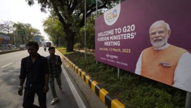 Commuters walk past a banner with Indian Prime Minister’s Narendra Modi photograph welcoming delegates of the G-20 foreign ministers meeting, in New Delhi, India, March 1, 2023. Credit: AP Photo/Manish Swarup