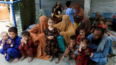 FILE PHOTO: Muhammad Ismail, 40, sits with his family while they are waiting to cross main Afghanistan-Pakistan land border crossing, in Torkham, Pakistan September 15, 2023. REUTERS/Fayaz Aziz/File Photo