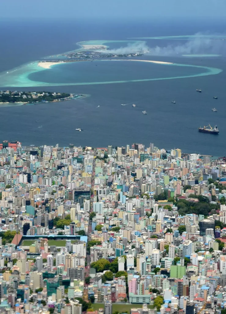 An aerial view of the island of Male and nearby Thilafushi Island (top). There was an unwritten understanding that the Male-Thilafushi project would be awarded to China after Yameen came back to power. | Photo Credit: Roberto Schmidt/AFP