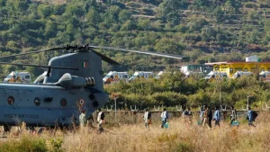 Workers, who were rescued from a tunnel which collapsed in Uttarkashi, walk to board an Indian Air Force's Chinook helicopter to be airlifted to AIIMS Rishikesh hospital, in Chinyalisaur, in the northern state of Uttarakhand, India, November 29, 2023. REUTERS