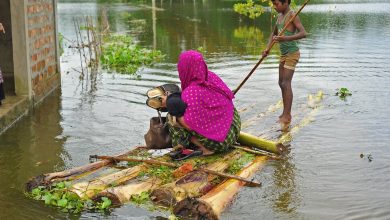 People travelling through flood waters by raft, June 26, 2022, in the Daudpur Union of Dakkin Surma Upazila of Sylhet.(MD RAFAYAT HAQUE KHAN/EYEPIX GROUP/FUTURE PUBLISHING/GETTY IMAGES)