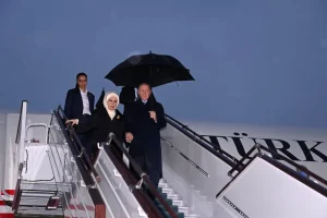 Turkey's President Erdogan (R) and his wife arrive in Tashkent, Uzbekistan for the Economic Cooperation Organisation summit [Uzbekistan Foreign Ministry via AFP]