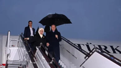 Turkey's President Erdogan (R) and his wife arrive in Tashkent, Uzbekistan for the Economic Cooperation Organisation summit [Uzbekistan Foreign Ministry via AFP]
