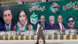 A man walks next to a billboard displaying photos of politician Bilawal Bhutto and his sister Asifa Bhutto, a day after general elections in Karachi, Pakistan February 9, 2024. REUTERS/Akhtar Soomro/File Photo