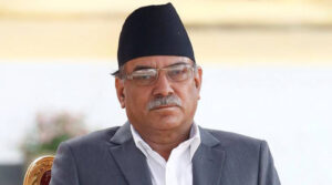 Newly elected Nepalese Prime Minister Pushpa Kamal Dahal, also known as Prachanda, (L) sits on a chair upon his arrival to administers the oath of office at the presidential building