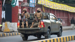 Military troops patrol near a polling station during Pakistan’s national elections in Lahore on 8 February.Photographer: Aamir Qureshi/AFP/Getty Images