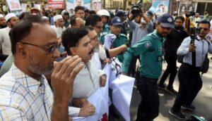 Police obstruct a procession, brought out of by the 12-Party Alliance with a call to boycott Indian goods, in front of the National Press Club on 24 February, 2024.