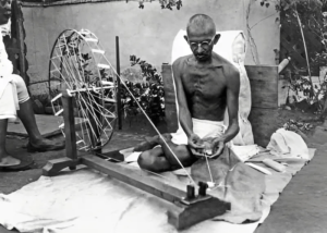 Picture of Gandhi during The Swadeshi Movement, with a trend for not using foreign goods and replace with  ‘Make in India’. This movement was also launched to motivate using goods produced in their nation.