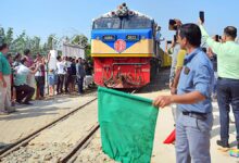 People gather as the Akhaura-Agartala rail link enters the Indo-Bangladesh border during its trial run, at Nischintapur, in Agartala | Photo Credit: ANI