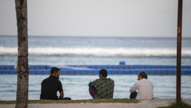 A group of migrant workers sit by the beach in Hulhumale'. (File Photo/Sun/Fayaz Moosa)