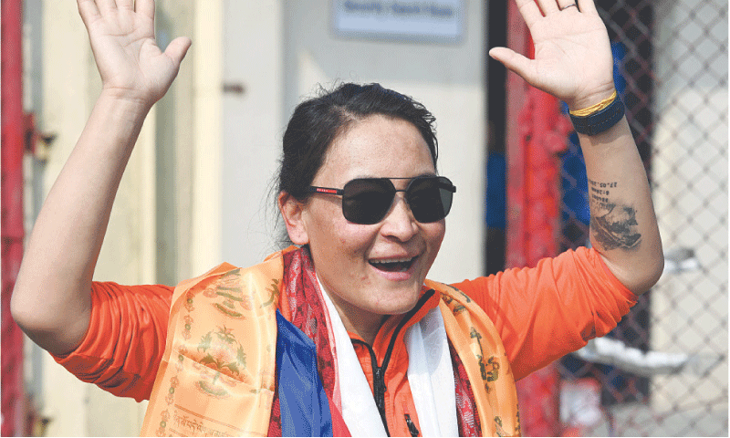 Kathmandu: Mountaineer guide Phunjo Lama greets the crowd upon her arrival at the Tribhuvan International airport, on Sunday.—AFP